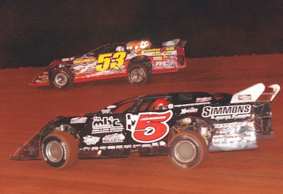 Ray Cook (53) holds off Ronnie Johnson (5) at TST. (Brian McLeod)