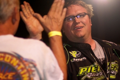 Jason Feger gets a high-five from car builder Bob Pierce in victory lane. (DirtonDirt.com)