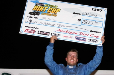 J.R. Hotovy holds up the winner's paycheck. (Steve Datema)