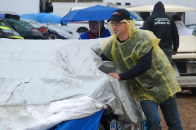 Josh McGuire tries to stay dry in the tech inspection line. (DirtonDirt.com)