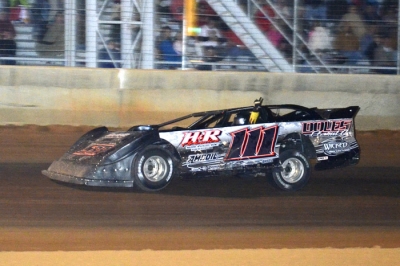 Stacy Roberts raises an arm as he takes the checkers at Needmore. (Troy Bregy)