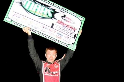 Tony Jackson Jr. shows off his big check in victory lane. (Ron Mitchell)