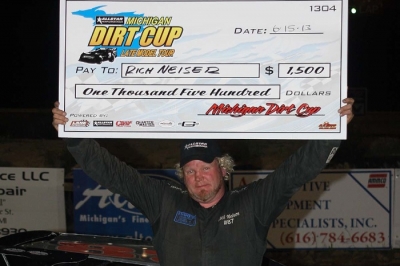 Rich Neiser shows off his big check at I-96 Speedway. (Jim DenHamer)