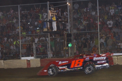 Shannon Babb takes the checkers after a hard-fought Summernationals race. (Jim DenHamer)