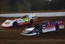 Ryan Unzicker (24) and Ethan Dotson (74) battle for the lead at Peoria Speedway in April 25's $5,098-to-win MARS-sanctioned Garry Swibold Memorial. (joshjamesartwork.com)