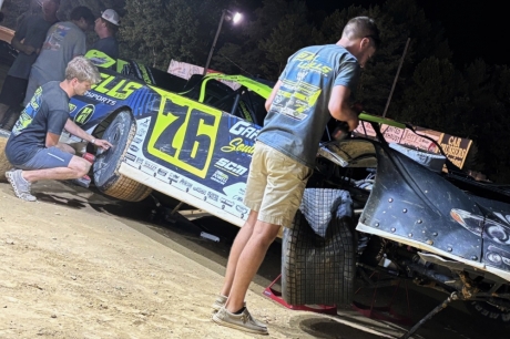 Crew members work on Brandon Overton's wrecked ride. (DirtonDirt.com)