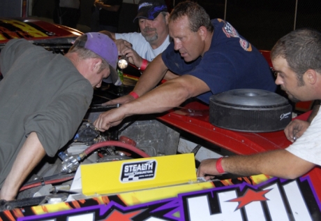 Tim Lance (center) makes preparations at Peoria. (Rich Edwards Jr.)