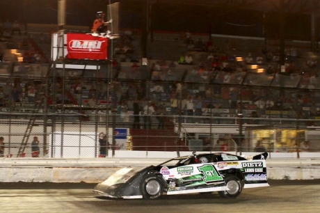 Brian Diede takes the checkers with a fist out of the window. (crpphotos.com)