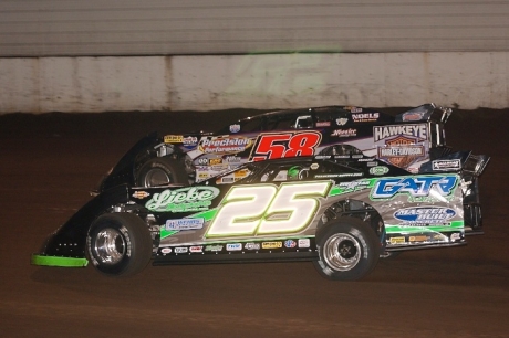 Winner Chad Simpson (25) works under leader Dave Eckrich (58) at Highway 3 Raceway. (K.C. Rooney)