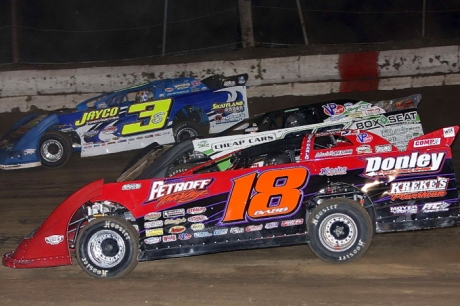 Jason Feger battles three wide with Shannon Babb (18) and Brian Shirley (3). (Jim DenHamer) 