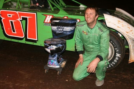 Walker Arthur picks up his custom-made trophy at Clarksville. (straightcircles.com)