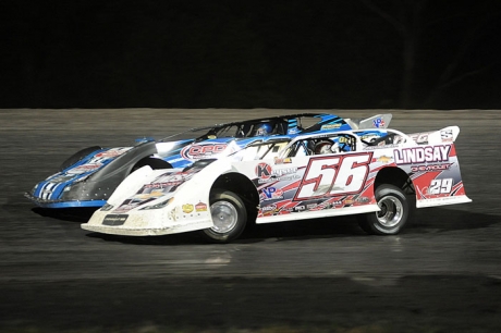 Tony Jackson (56) fights past Ryan Gustin at Adams County. (Todd Boyd)