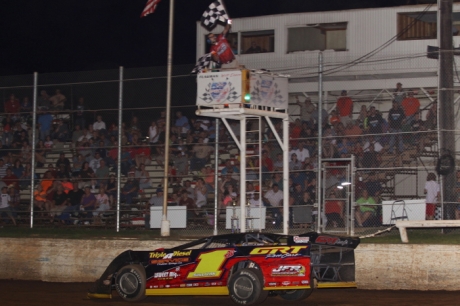 Jack Sullivan takes the checkers at I-30 Speedway. (Woody Hampton)