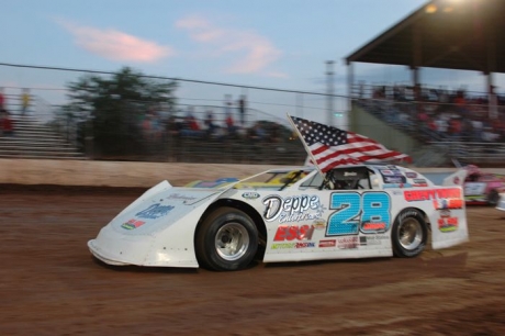 Jimmy Mars displays Old Glory before his victory. (chrisburback.com)