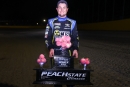 Ricky Thornton Jr. poses with his Peach State Classic winner&#039;s trophy after capturing Nov. 16&#039;s 75-lap Castrol FloRacing Night in America weekend finale at Senoia (Ga.) Raceway. (joshjamesartwork.com)